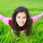Happy girl in green wheat field