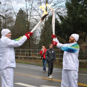 Olympic Torch Bearers Passing the Flame